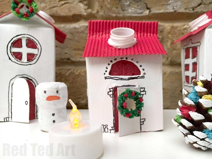 Winter Village Luminary DIY. We adore these cute Juice Carton Luminaries. They are fun to make and add a lovely little something to the Winter months. Use them as night lights or Christmas Decorations. Love adding lots of little details like mini pine cone Christmas Trees, snowmen and mini wreaths. All made mainly from recycled materials or nature finds!