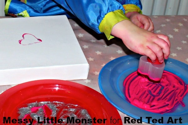 Cookie Cutter Heart Art - a wonderful Valentine Project for Preschoolers and Toddlers. Love how cheerful and fun these Heart Print Canvases are. A great process for DIY gift wrap and valentine gift bags too!
