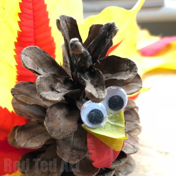 Autumn Leaf Pine Cone Turkey - Wow! These Pine Cone Turkeys really show the vibrant colours of beautiful Autumn Leaves. A great (quick) Thanksgiving Craft for Kids. Adorable!!