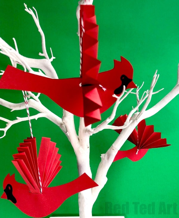 Easy Paper Fan Cardinal Ornament for Christmas. How to make a paper fan bird. This stunning red bird ornament is a beautiful Christmas Ornament. Make it from scratch or make use of the handy Cardinal Template. Aren't they simply vibrant? Love paper crafts for Christmas! #papercrafts #paperbird #papercraftsforkids #paperornaments #ornament #cardinal #papercardinal