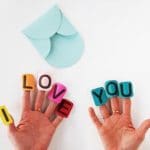 A cute Valentine's Gift for Kids to make - easy Heart Pom Pom Pin! An easy Kids' Valentine's Day Craft to keep or give to a loved one. #valentines #pompoms #hearts #gifts