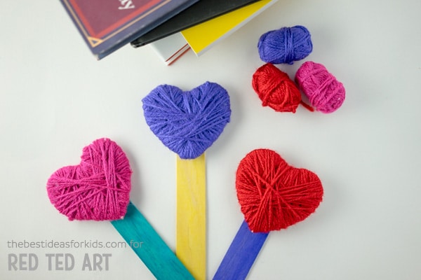 Yarn Wrapped Heart Bookmarks. A great fine motor skills activity for Valentine's Day. Not only are these little Yarn Heart Bookmarks gorgeous, but they make a great practical gift on Valentines or Mother's Day #valentines #valentinesday #mothersday #giftskidscanmake #hearts #bookmarks