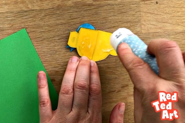 gluing a paper trophy to the card