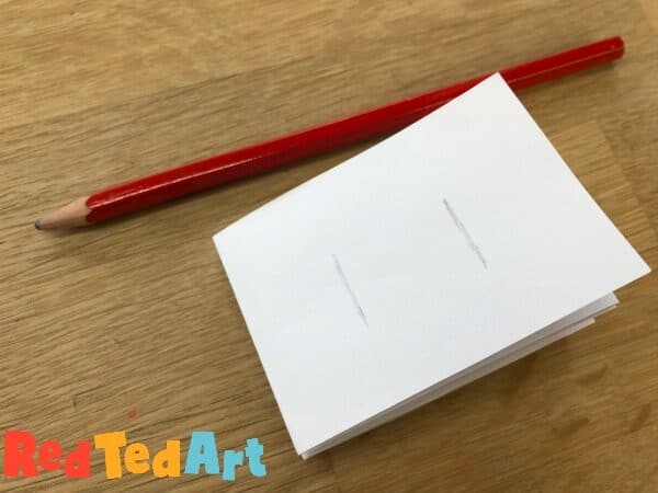 Making snips into your mini notebook to hold the paper locks