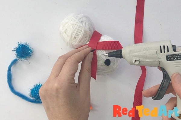 hot gluing the snowman's features