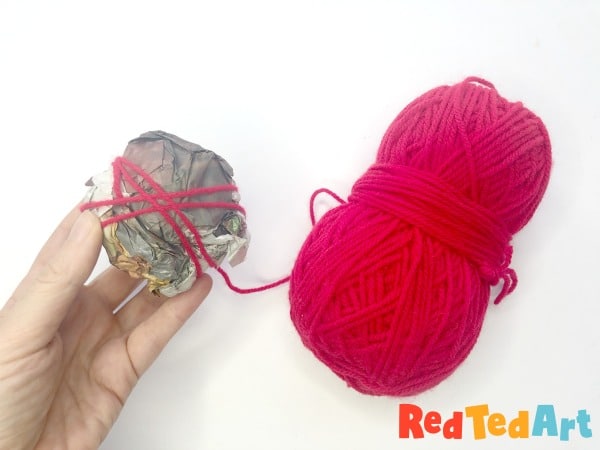 yarn wrapped around newspaper