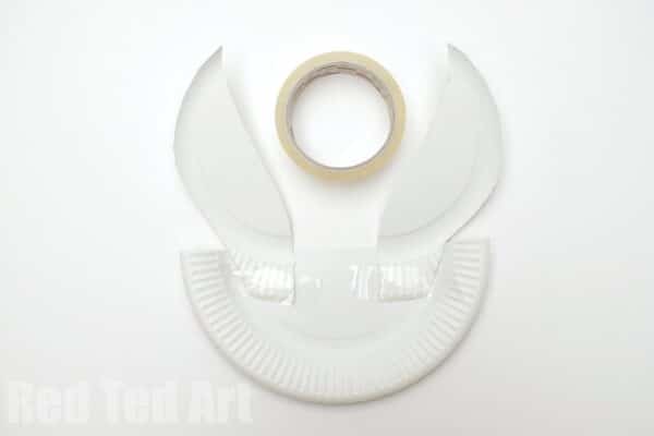 tape the ears to one half of the paper plate