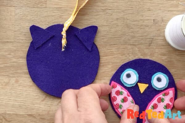 position the ears and hanging thread for sewing