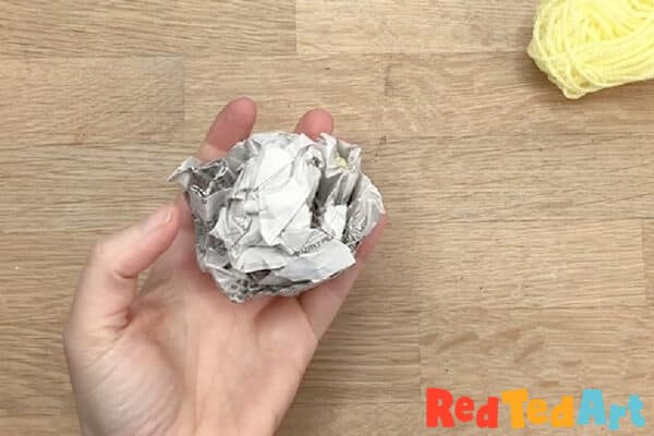 make a tight newspaper ball