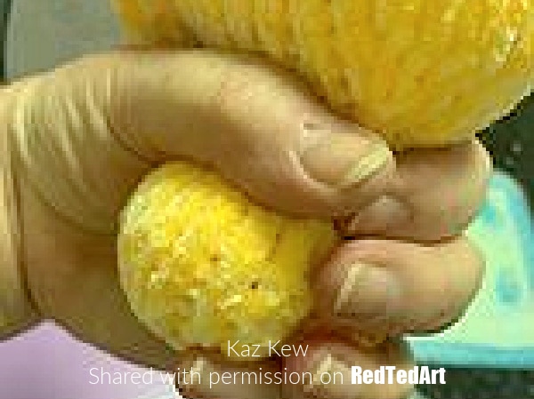 stuffing the knitted rubber duck's head to shape it