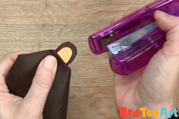 Staple ear in place and draw bear features