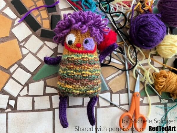 finished cute knitted monster cuddly toy