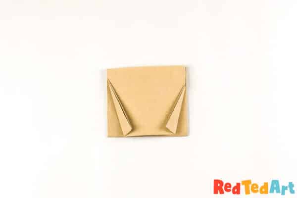 Fold down the corners to shape